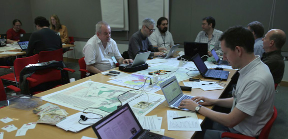 Photo shows people with computers and maps at the event